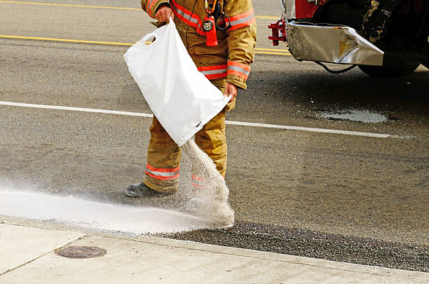 Fire fighers spreading absorbant at a four vehicle accident involving two large trucks resulted in a single injury and a diesel fuel spill. July 17, 2012 in Roseburg Oregon